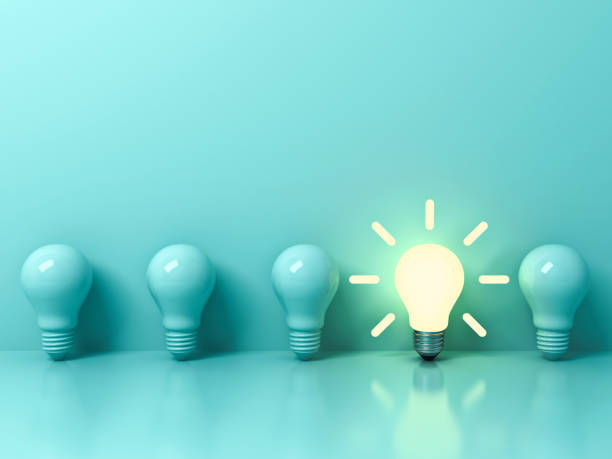 istock One glowing idea bulb standing out from unlit incandescent bulbs on light green pastel color background with reflection and shadow , individuality and different creative idea concepts . 3D rendering 854329272