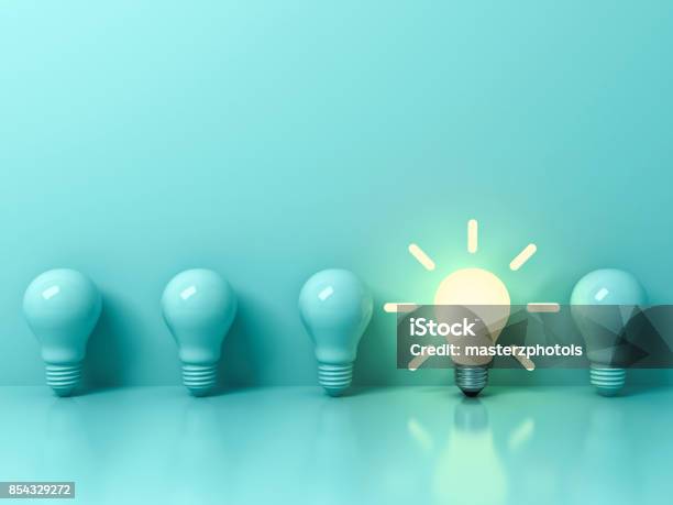 One Glowing Idea Bulb Standing Out From Unlit Incandescent Bulbs On Light Green Pastel Color Background With Reflection And Shadow Individuality And Different Creative Idea Concepts 3d Rendering Stock Photo - Download Image Now