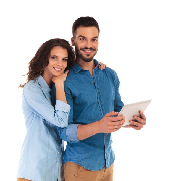 istock smiling happy casual couple with a tablet pad computer 854330514