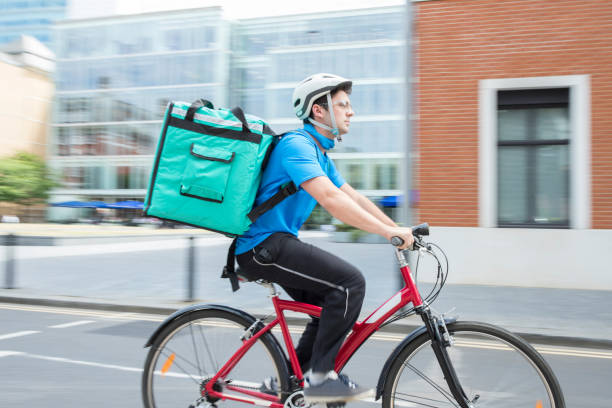 istock Courier On Bicycle Delivering Food In City 854337412