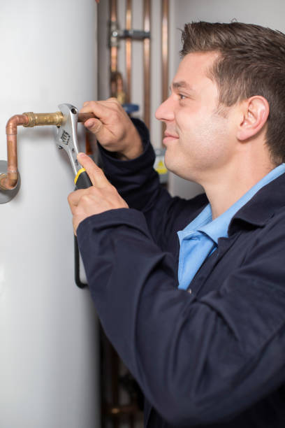 istock Male Plumber Working On Central Heating Boiler 854340370