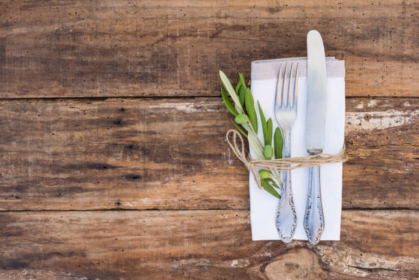 Rustic cutlery place setting Table place setting with old silverware and wooden table. napkin photos stock pictures, royalty-free photos & images