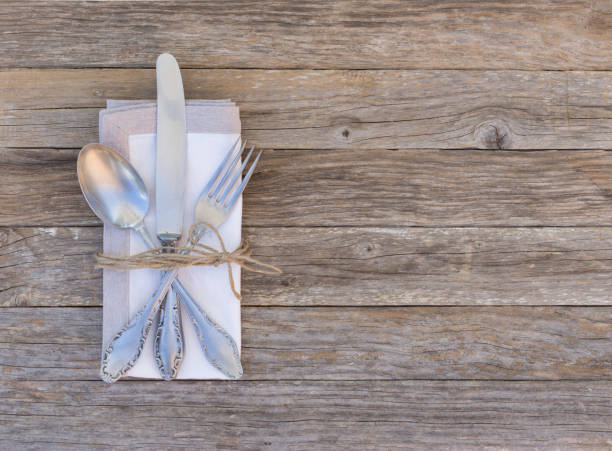 istock Vintage silver cutlery table place setting with napkin 854343574