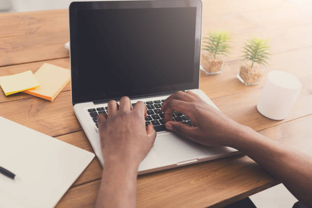 istock African-american businessman in office type on laptop 854344606