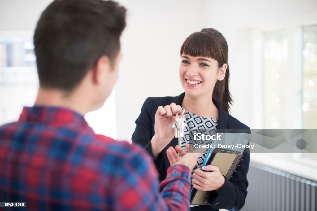 Man Collecting Keys To New Home From Female Real Estate Agent Real Estate Agent Stock Photo