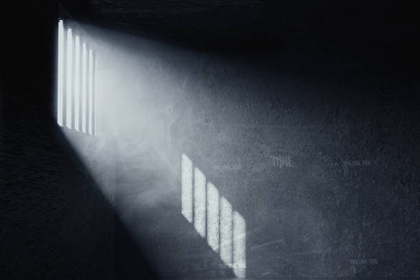 3d rendering of grunge prison cell with the shadows of stanchions projected on wall from light ray on window stock photo