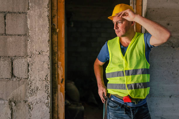 istock Mature Construction worker holding his yellow helmet 854350514