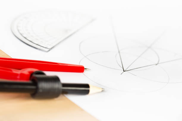 istock Mathematical compasses with geometrical drawing in background 854353578