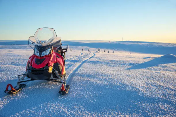 Snowmobile in a snowy landscape in Lapland, near Saariselka, Finland