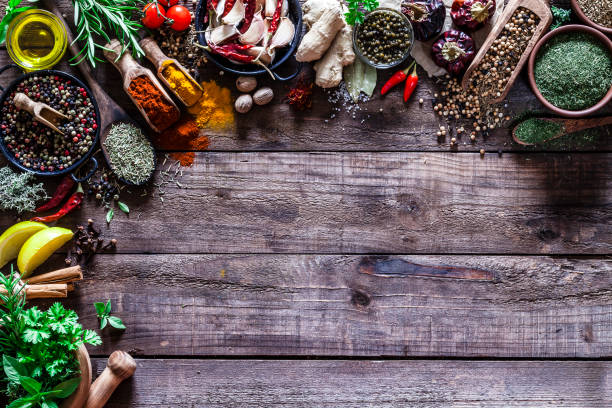 istock Spices and herbs border on rustic wood kitchen table 854359138