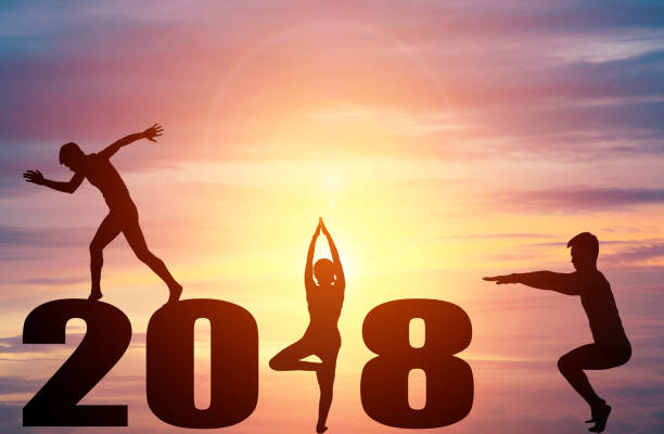 istock Silhouette young people practicing yoga on 2018 new year 854363958