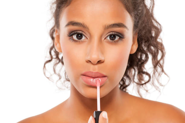 istock young beautiful black woman applied lipstick 854368914