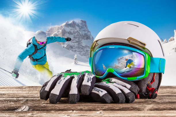 Ski goggles with reflection of winter mountains with skier.