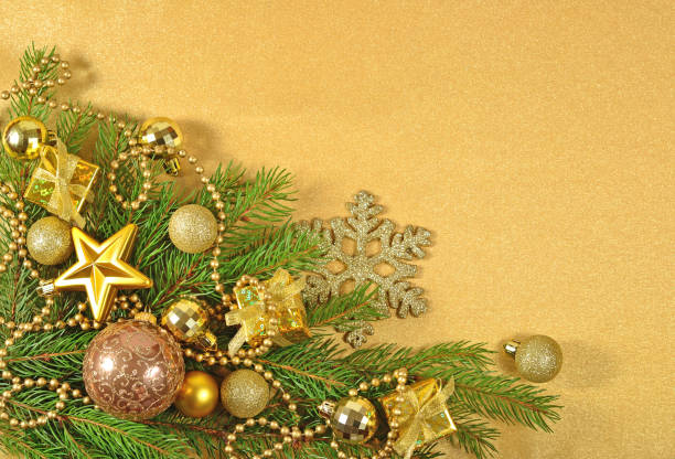 istock Golden Christmas decorations on a spruce branch 854369492