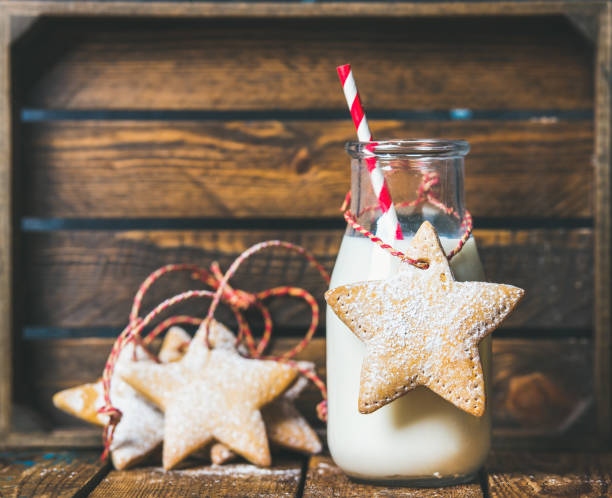 istock Christmas festive gingerbread star shaped cookies and bottle with milk 854369632