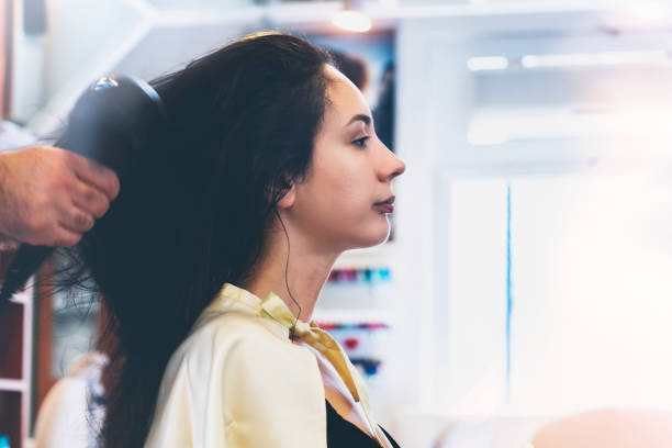 istock Making hairstyle using hair dryer 854369782