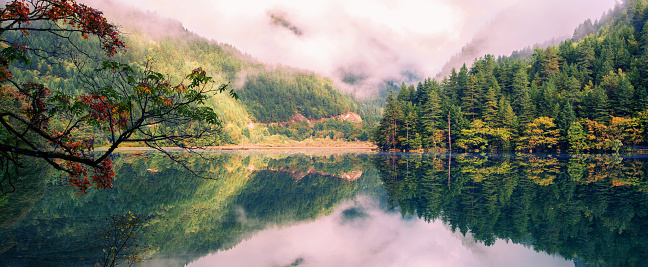 Fall color and lake at Jiuzhaigou, Sichuan, China.Jiuzhaigou Valley is a national park located in northwest Sichuan province. It is famous for many multi-colored lakes, waterfalls and snow-capped peaks and is often compared to the Yellowstone National Park in Wyoming.It is a UNESCO World Heritage site.