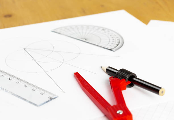 istock Set of math instruments with diagrams on white paper 854370216