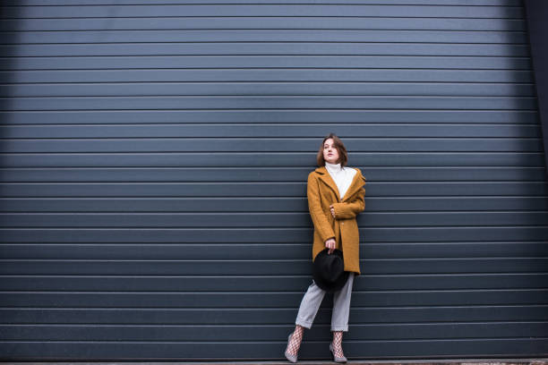 istock stylish woman in jacket and black hat 854374742