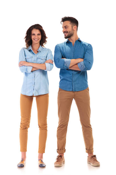 istock young casual man with hands crossed looks at his girlfriend 854377956
