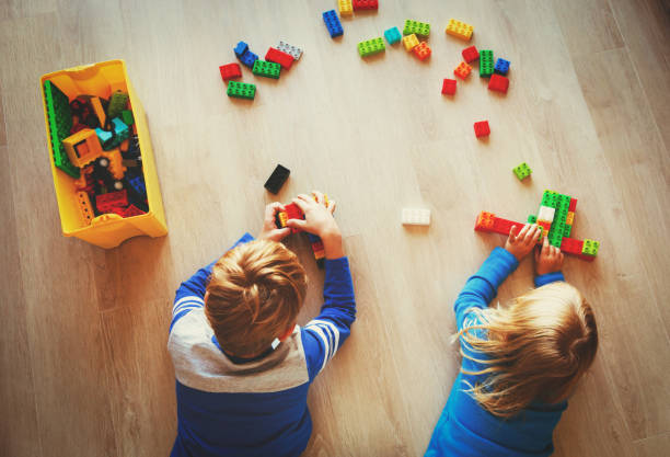 istock little boy and girl play with plastic blocks 854378904
