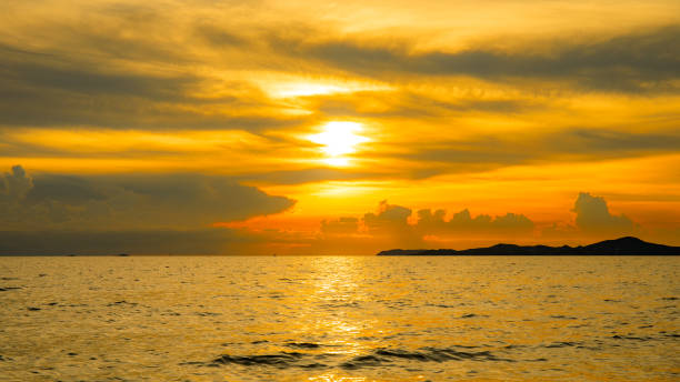 istock Sunset with sunlight over sea or ocean with orange or golden light tone. 854381730