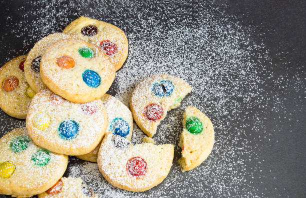 istock Chocolate chips and multicolored candy homemade shortbread cookies on gray background. Selective focus. Copy space 854385294