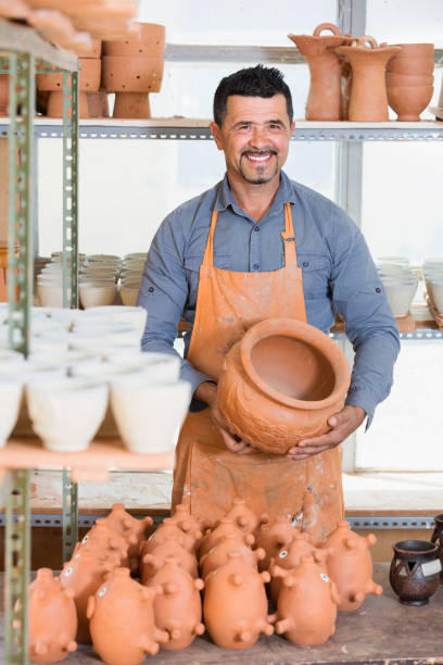 istock Happy male sculptor having ceramics in hands 854385690