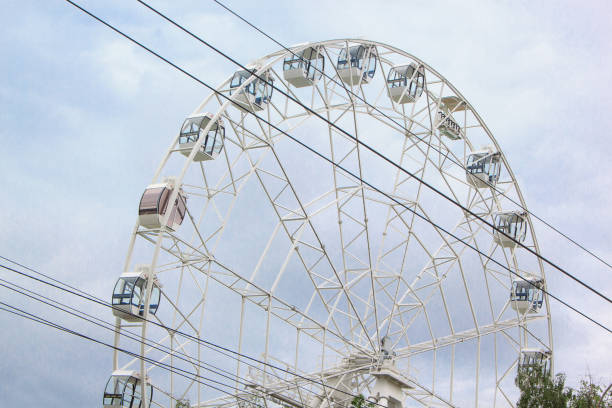 istock Large ferris wheel is spinning in an amusement park. 854386274