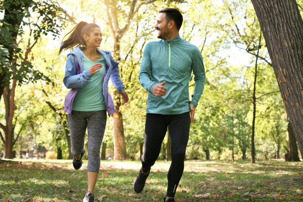 istock Young couple running together in park. Young people exercising. 854393992