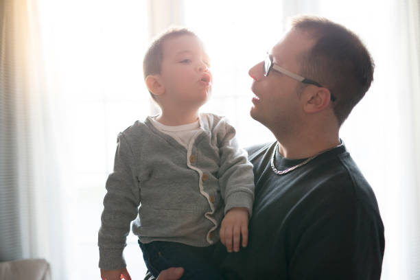 Young father and his child in front of the window A Young father and his child in front of the window 2000 photos stock pictures, royalty-free photos & images