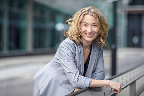 istock Confident businesswoman leaning on railing 854397780