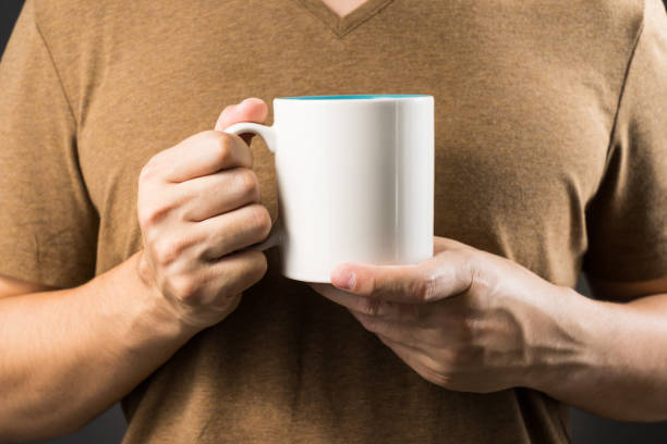 istock asian man holding coffee mug with copy space for your text 854397910