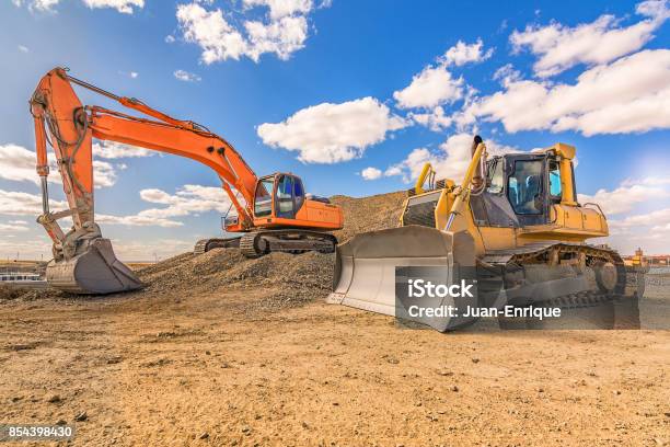 Heavy Machinery In Repair Works Of A Motorway Stock Photo - Download Image Now - Construction Site, Machinery, Construction Industry