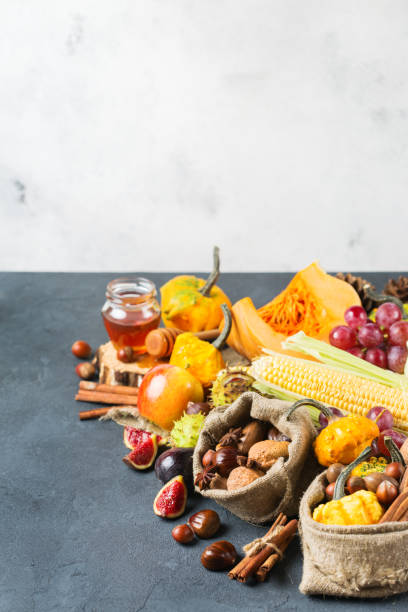 istock Fall autumn harvest thanksgiving background with pumpkin apple chestnut corn 854398608