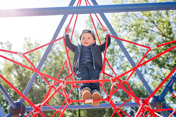 istock Happy little child boy climbed on playground 854401380