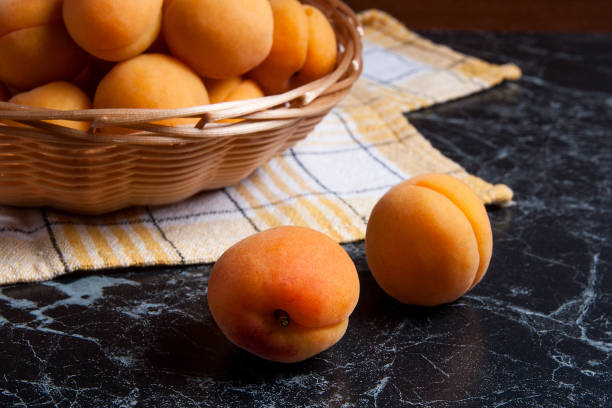 istock Group of harvested apricots in basket. 854402220