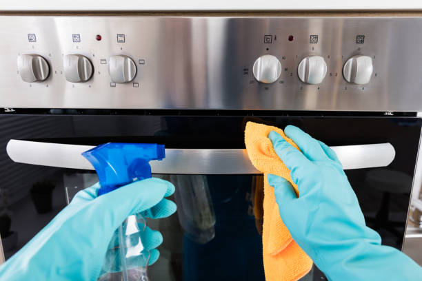 istock Janitor Cleaning Oven In The Kitchen 854402390