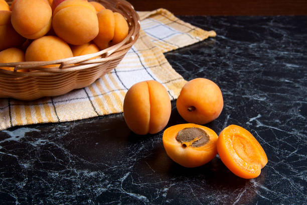 istock Group of harvested apricots in basket. 854405114