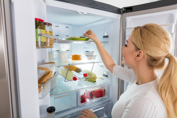 istock Woman Taking Food From Refrigerator 854405668