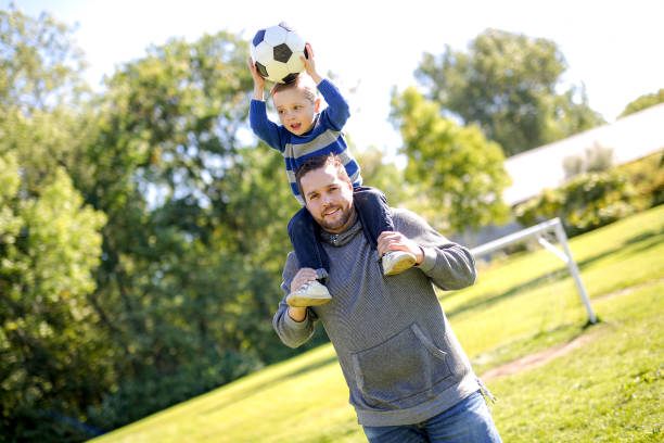 istock Father and Son Playing Ball in The Park 854406276