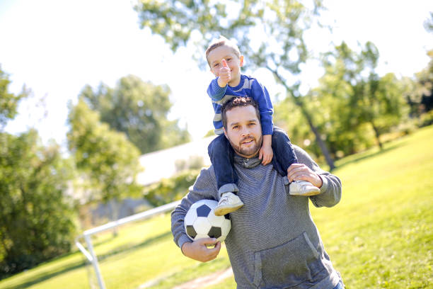 istock Father and Son Playing Ball in The Park 854406350