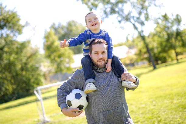 istock Father and Son Playing Ball in The Park 854406388