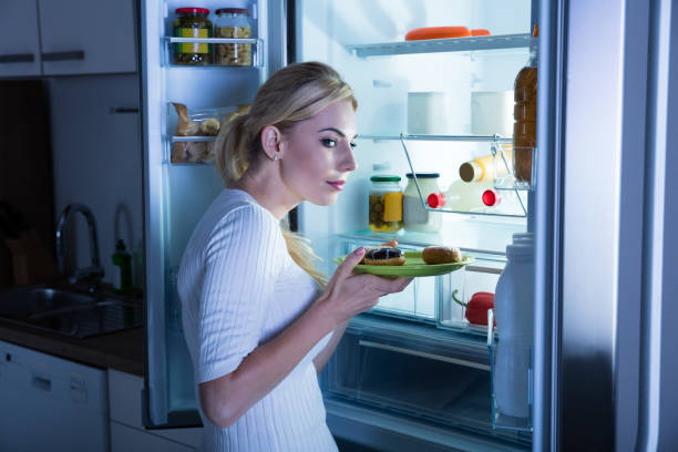 istock Suspicious Woman Taking Food From Fridge 854408456