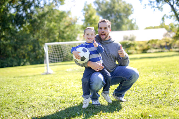 istock Father and Son Playing Ball in The Park 854408496