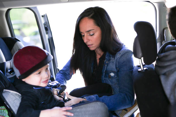 istock Mother securing her boy in the car seat in 854409162