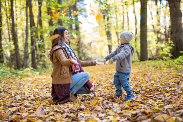 istock Mother with son in forest in autumn 854409838
