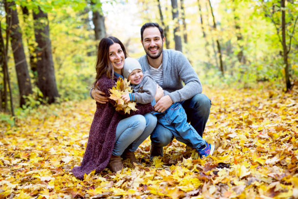 istock Happy family relaxing outdoors In autumn park 854410088
