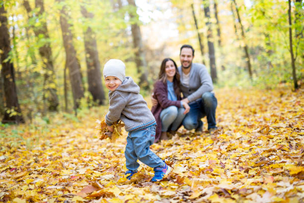 istock Happy family relaxing outdoors In autumn park 854410258