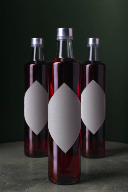 glass bottle with red liquid